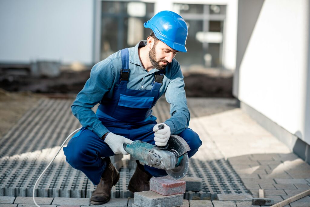 Builder cutting paving tiles